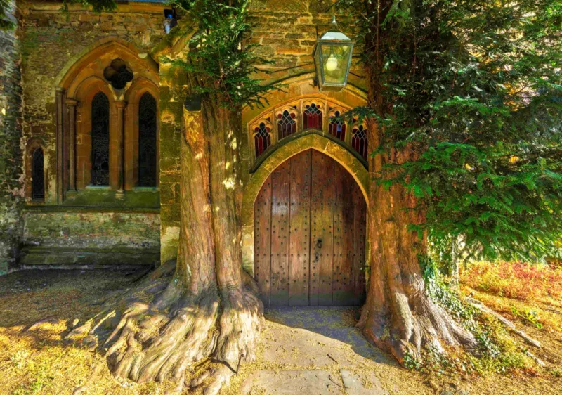 St Edward's Parish Church north door flanked by yew trees